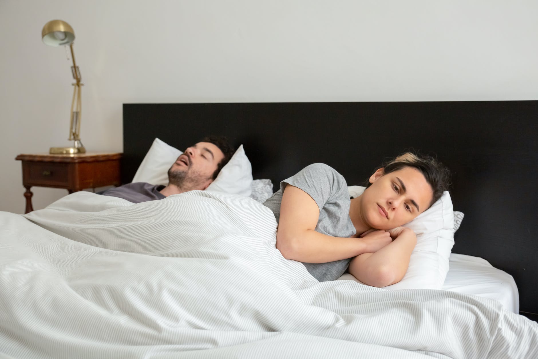 a couple lying down in bed